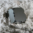 Cubic Bixbyite on Rhyolite Matrix